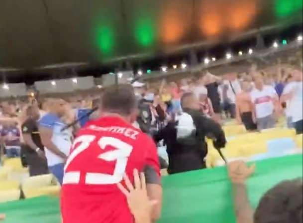 Goalkeeper Emiliano Martinez pictured trying to slap a baton from an officer's hand after witnessing clashes between police and Argentina fans at Brazil's Estadio do Maracana in November 2023
